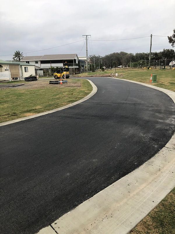 A Newly Paved Road is Going Through a Residential Area — North Coast Asphalts in Corindi Beach, NSW