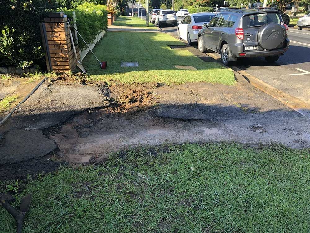 A Car is Parked on the Side of the Road Next to a Grassy Area — North Coast Asphalts in Corindi Beach, NSW