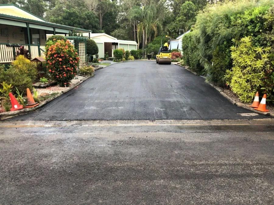 A Road is Being Paved in Front of a House — North Coast Asphalts in Corindi Beach, NSW