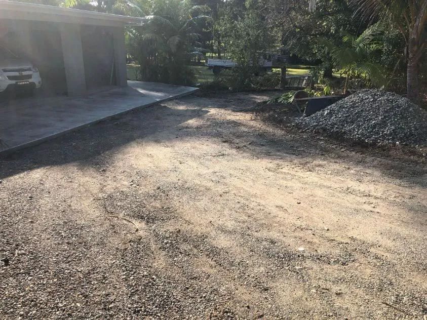 A Car is Parked in a Driveway Next to a House — North Coast Asphalts in Corindi Beach, NSW