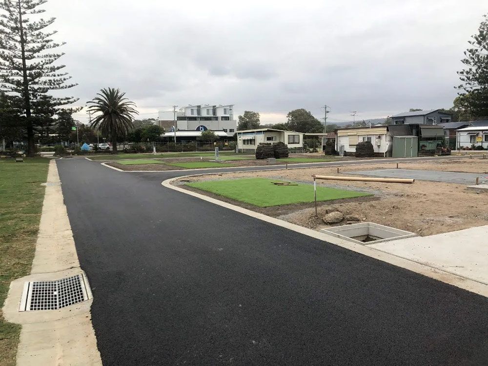 A Road With a Drain on the Side of It Going Through a Residential Area — North Coast Asphalts in Corindi Beach, NSW