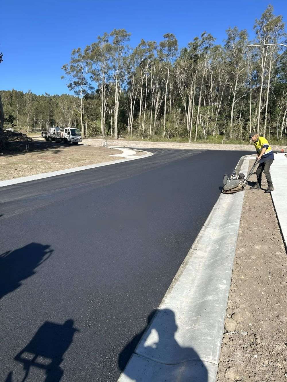 A Worker Compacts Fresh Asphalt on A New Road — North Coast Asphalts in Corindi Beach, NSW