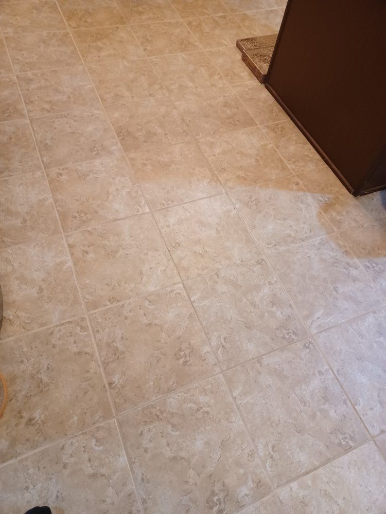 A close up of a tiled floor in a kitchen.