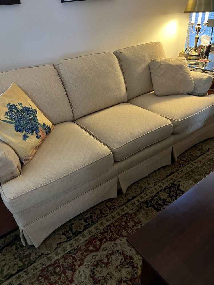 A living room with a couch and a rug