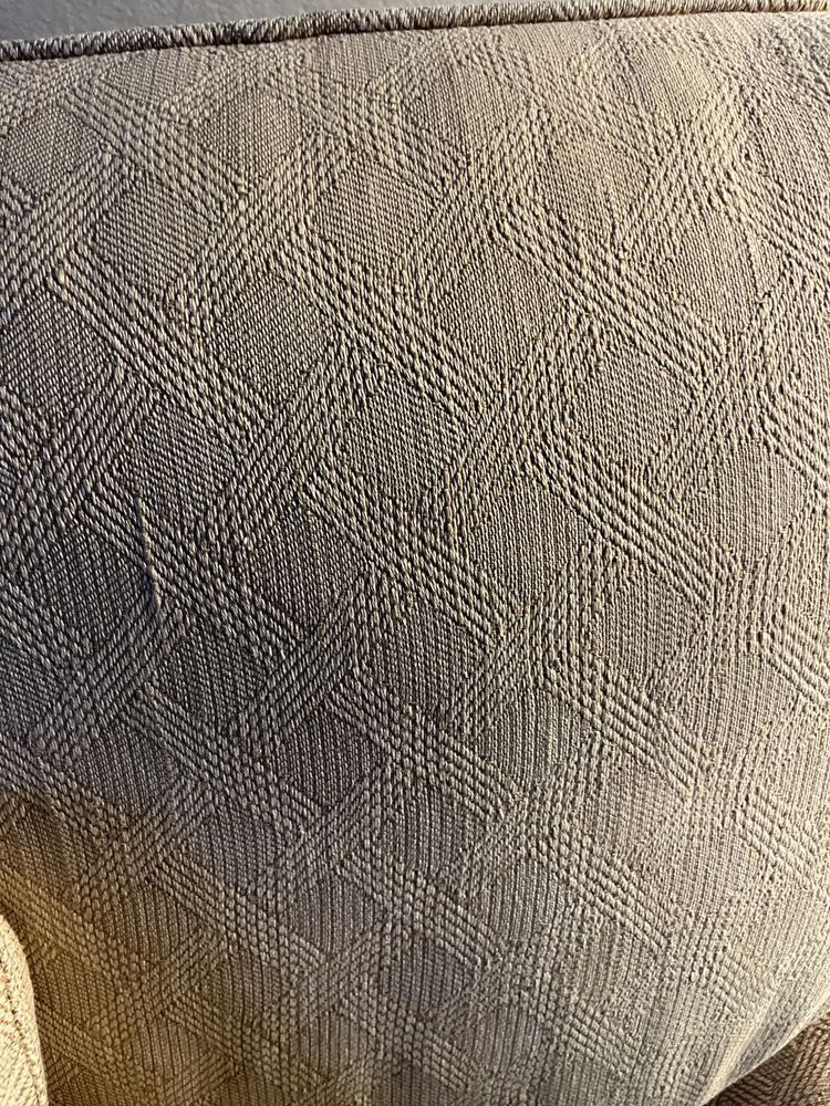 A close up of a couch cushion with a pattern on it.