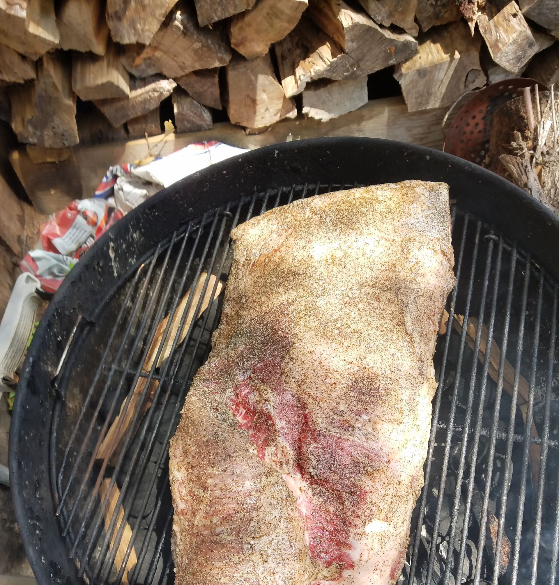 A large piece of meat is cooking on a grill