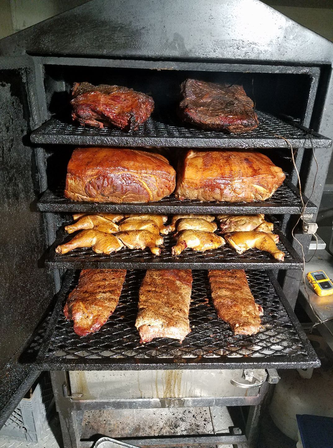 A smokehouse filled with lots of different types of meat.