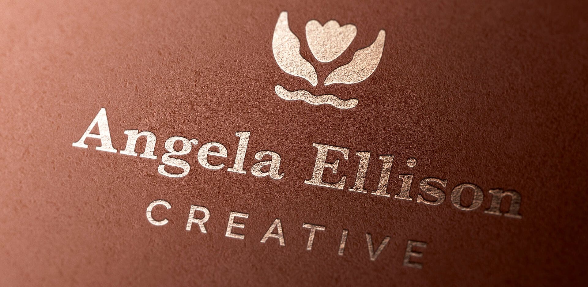 Woman-owned small business new primary logo. Foil stamped on copper colored textured paper.