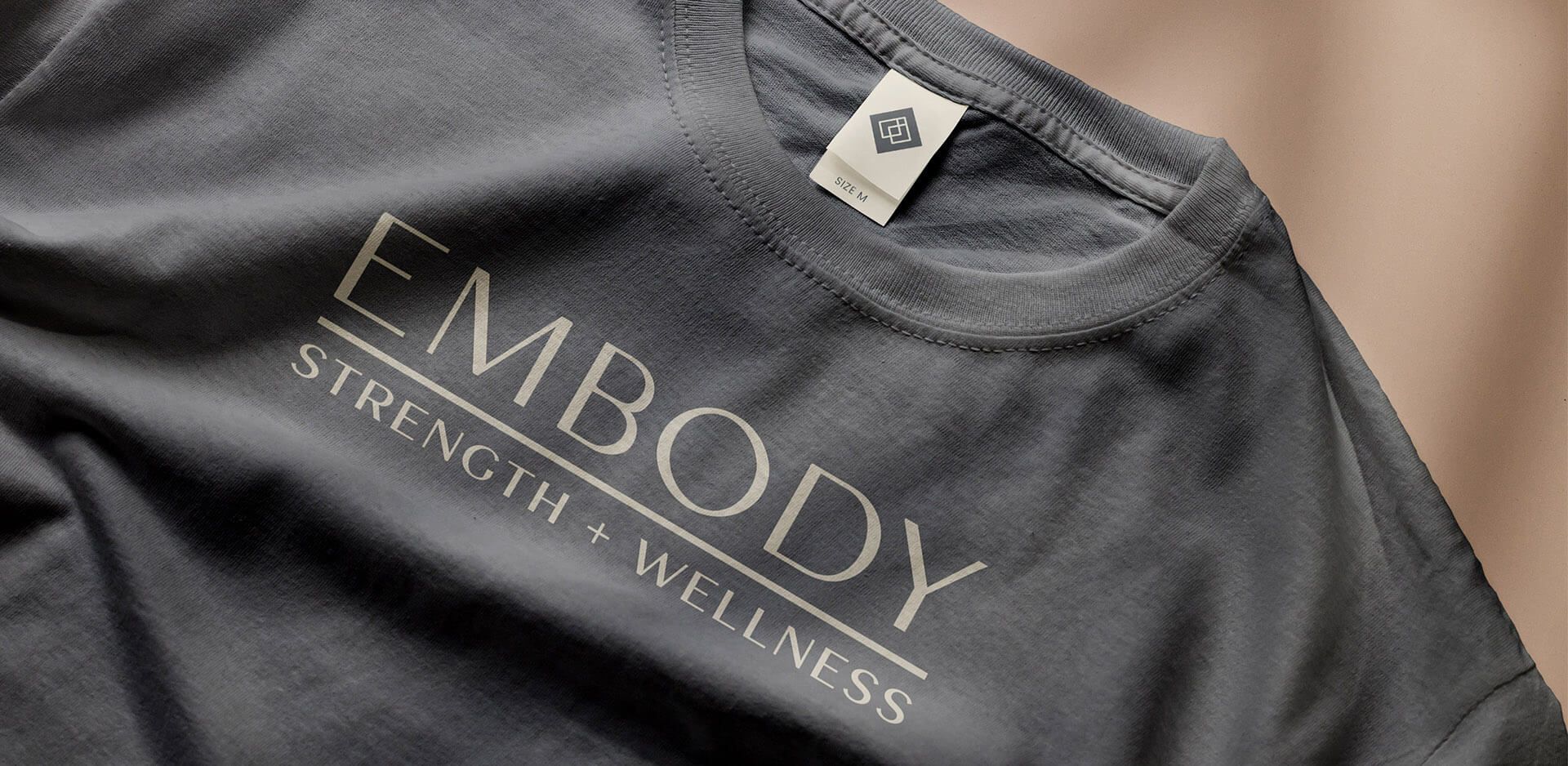 wordmark logo on a gray cotton t-shirt for a woman-owned business