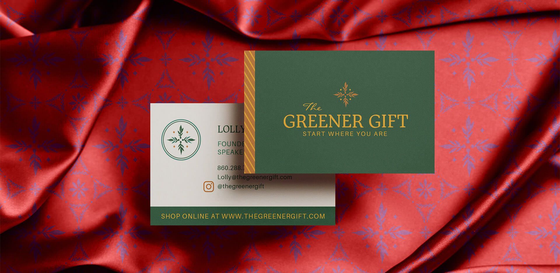 Business card front and back shown on top of a silky red patterned fabric for sustainably minded business.