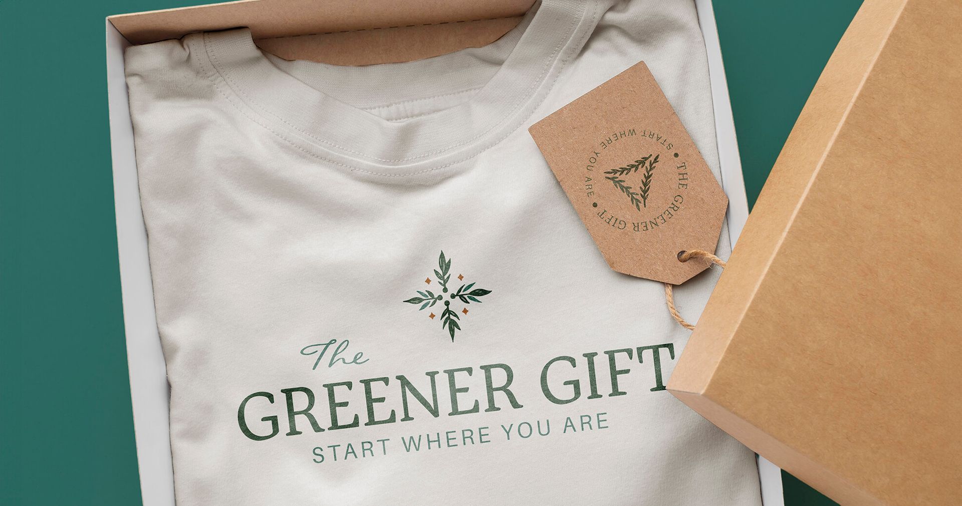 Apparel design for sustainable business. T-shirt shown folded neatly in a cardboard box with a kraft paper tag