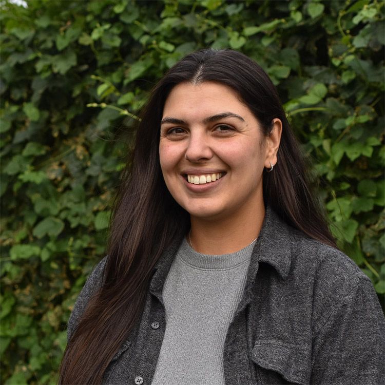 Sustainable small business owner smiling.