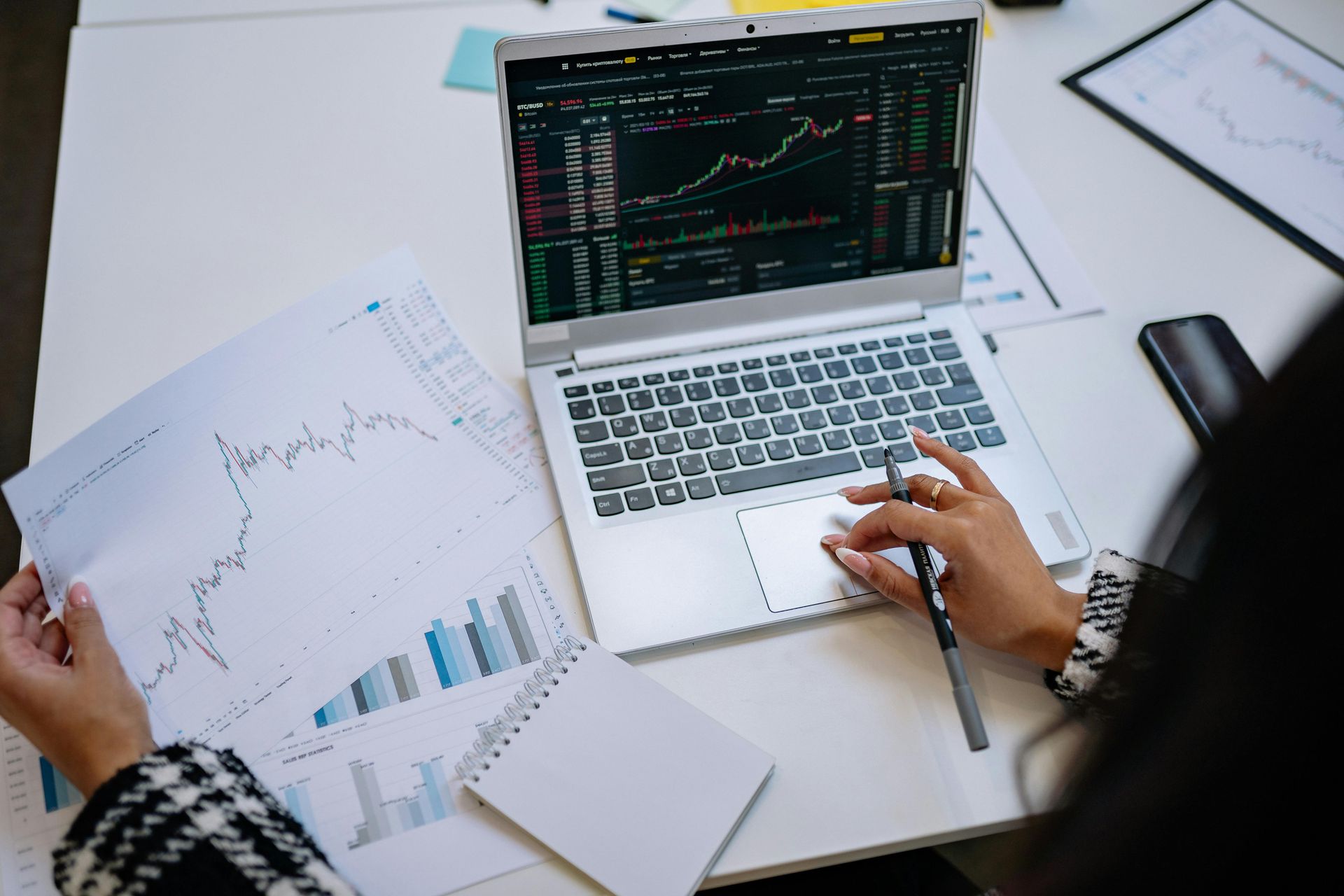 Photo of a woman facing a computer watching analytics.