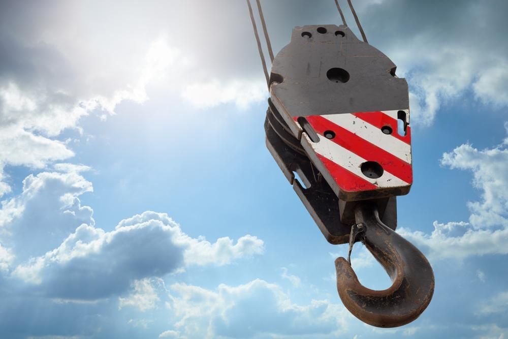 A Crane Hook Is Hanging in The Air Against a Cloudy Sky — Cheshire Machinery in Murgon, QLD