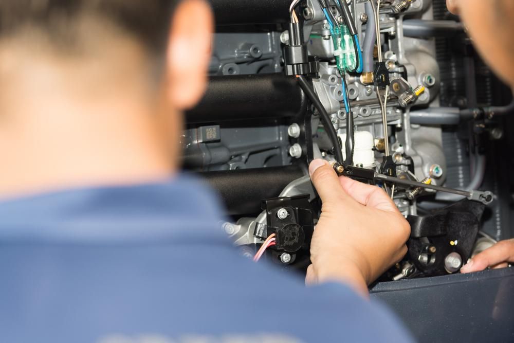 Two Men Are Working on A Boat Engine — Cheshire Machinery in Svensson Heights, QLD
