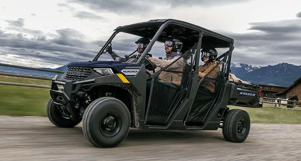 A Couple of People Are Riding a Four Wheeler on A Dirt Road — Cheshire Machinery in Svensson Heights, QLD