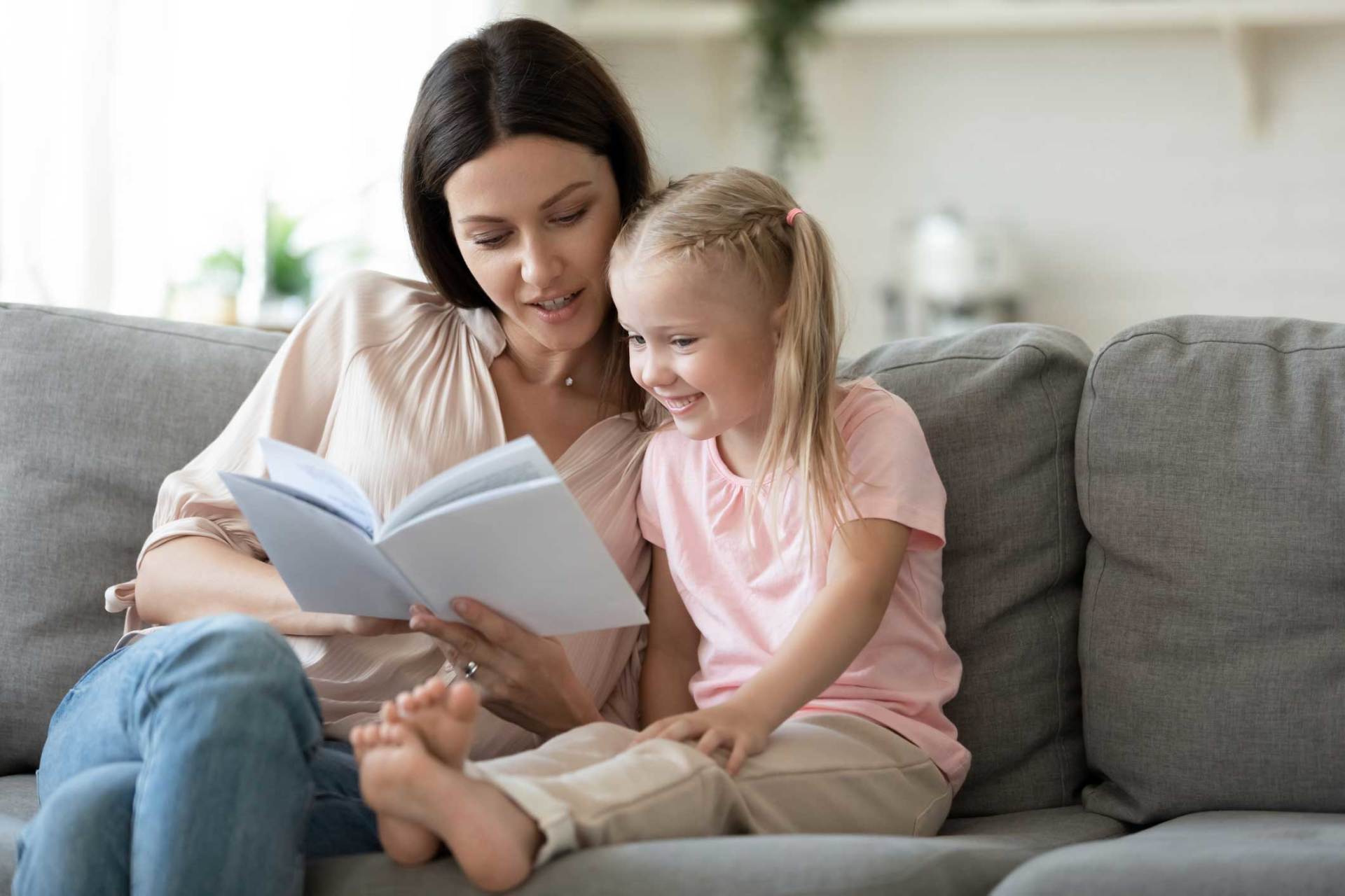 Loving Mother Teaching Little Daughter to Read at Home — Huntsville, AL — Elissa Green Attorney at Law