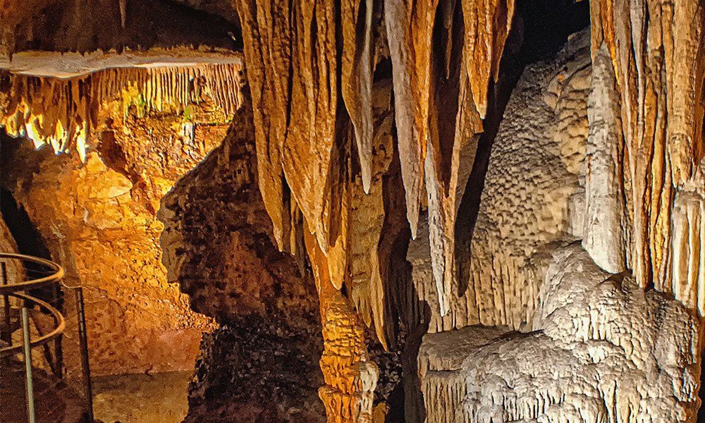 A cave with a lot of icicles hanging from the ceiling