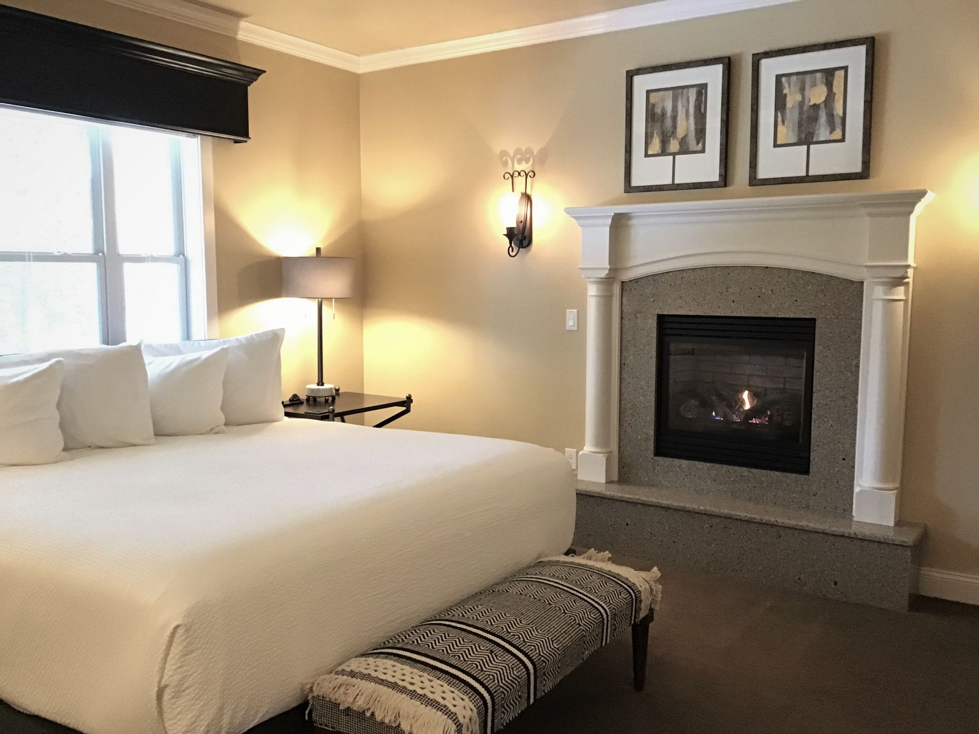 A bedroom with a king size bed and a fireplace