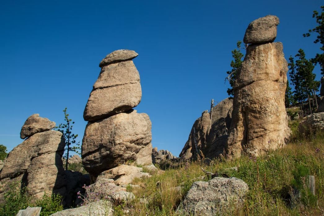 A group of rocks stacked on top of each other on top of a hill.