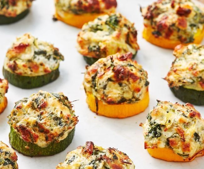 A bunch of stuffed zucchini and peppers on a table