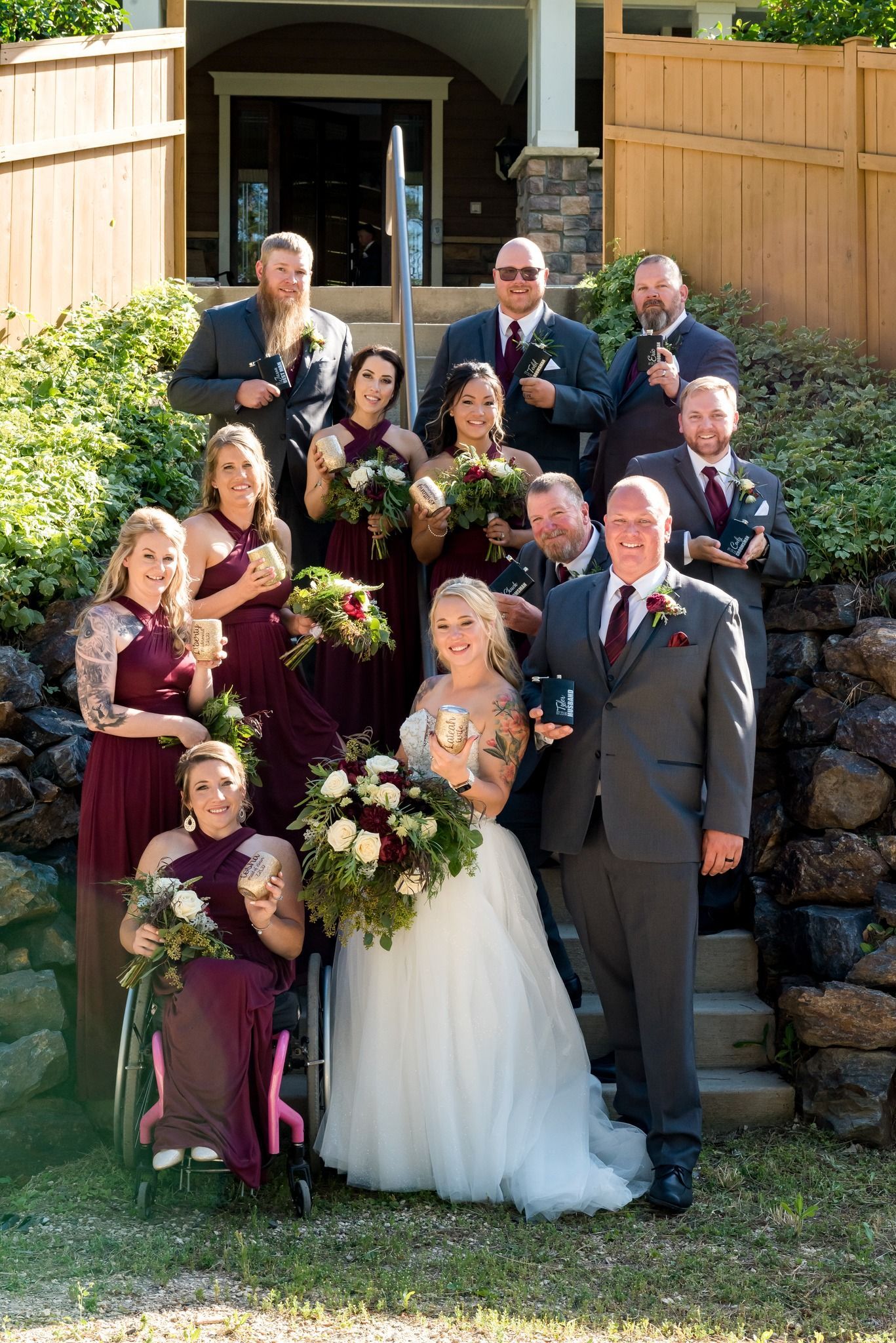 A bride and groom are posing for a picture with their wedding party.