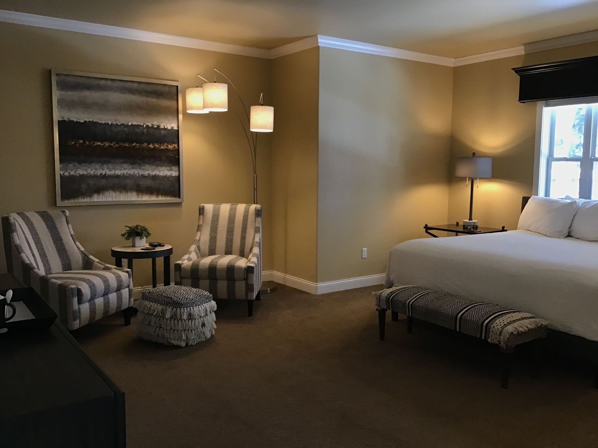 A bedroom with a bed , chairs and a table