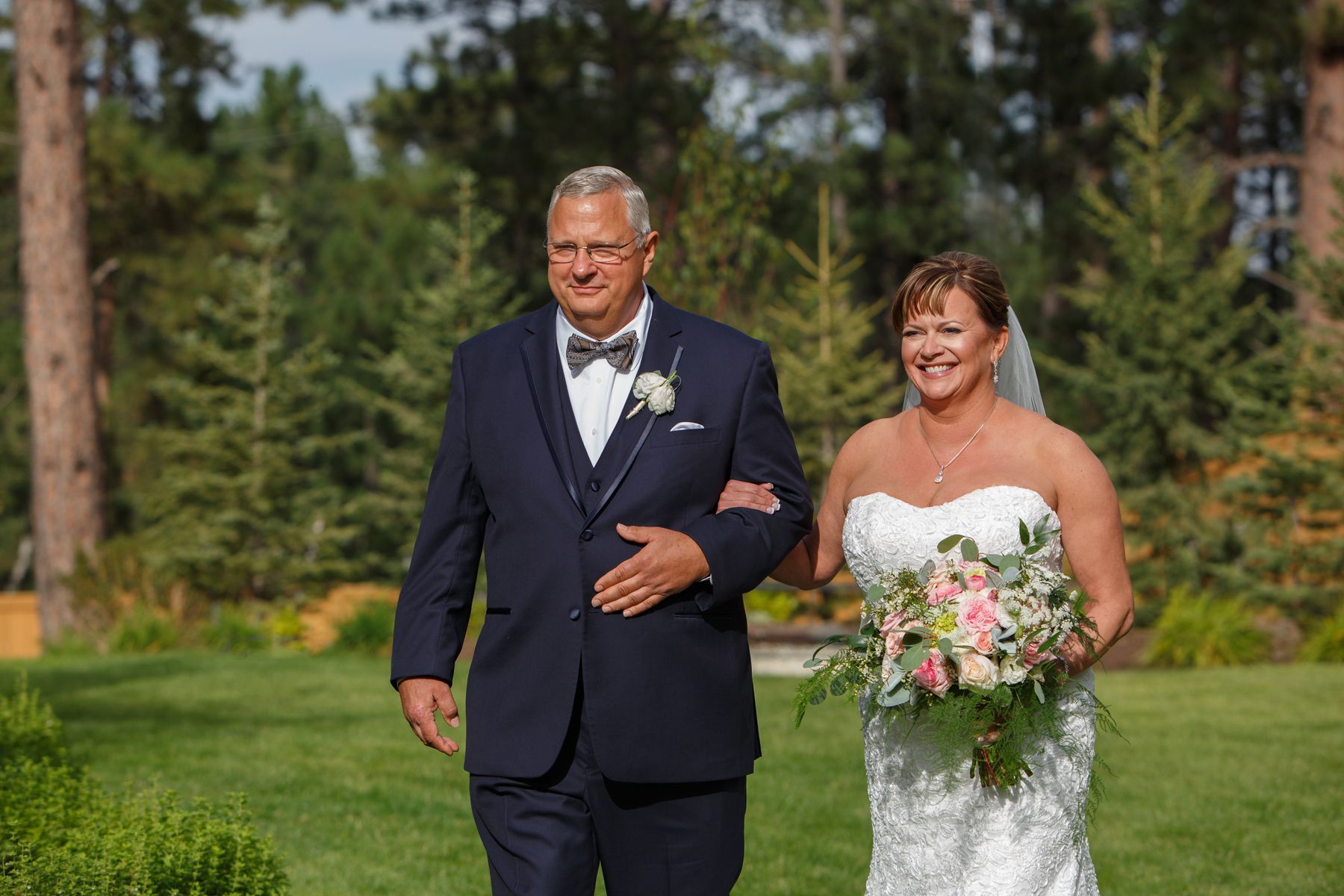 A bride and groom are walking down the aisle at their wedding.