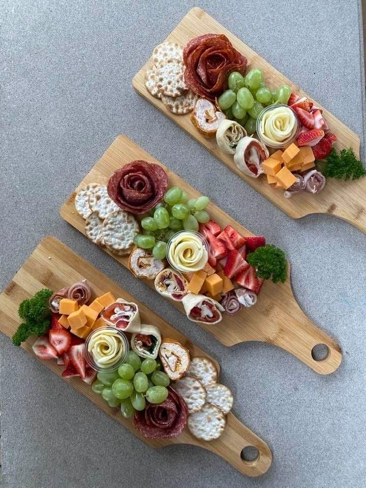 Three wooden cutting boards filled with different types of food.