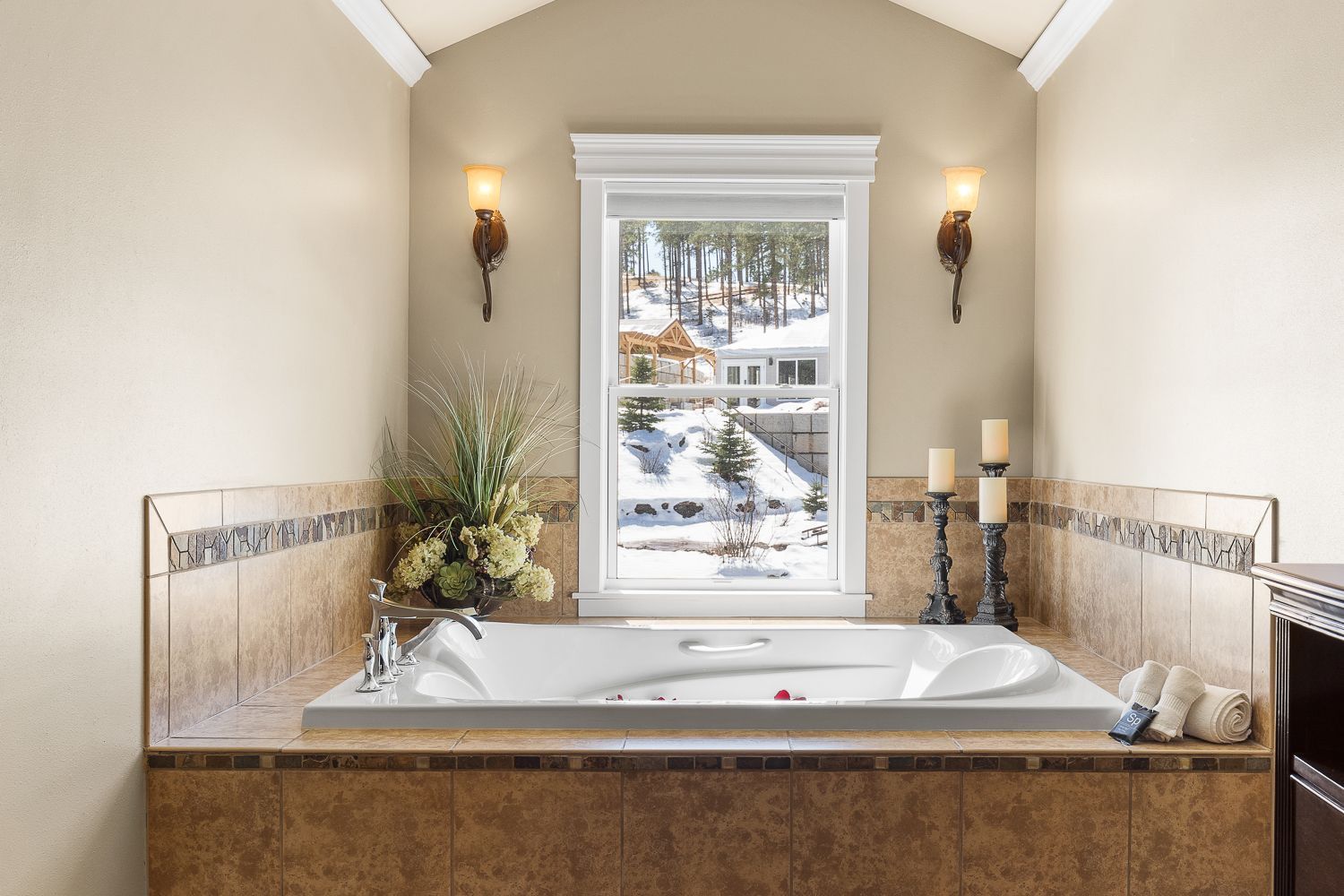 A bathroom with a large tub and a window.