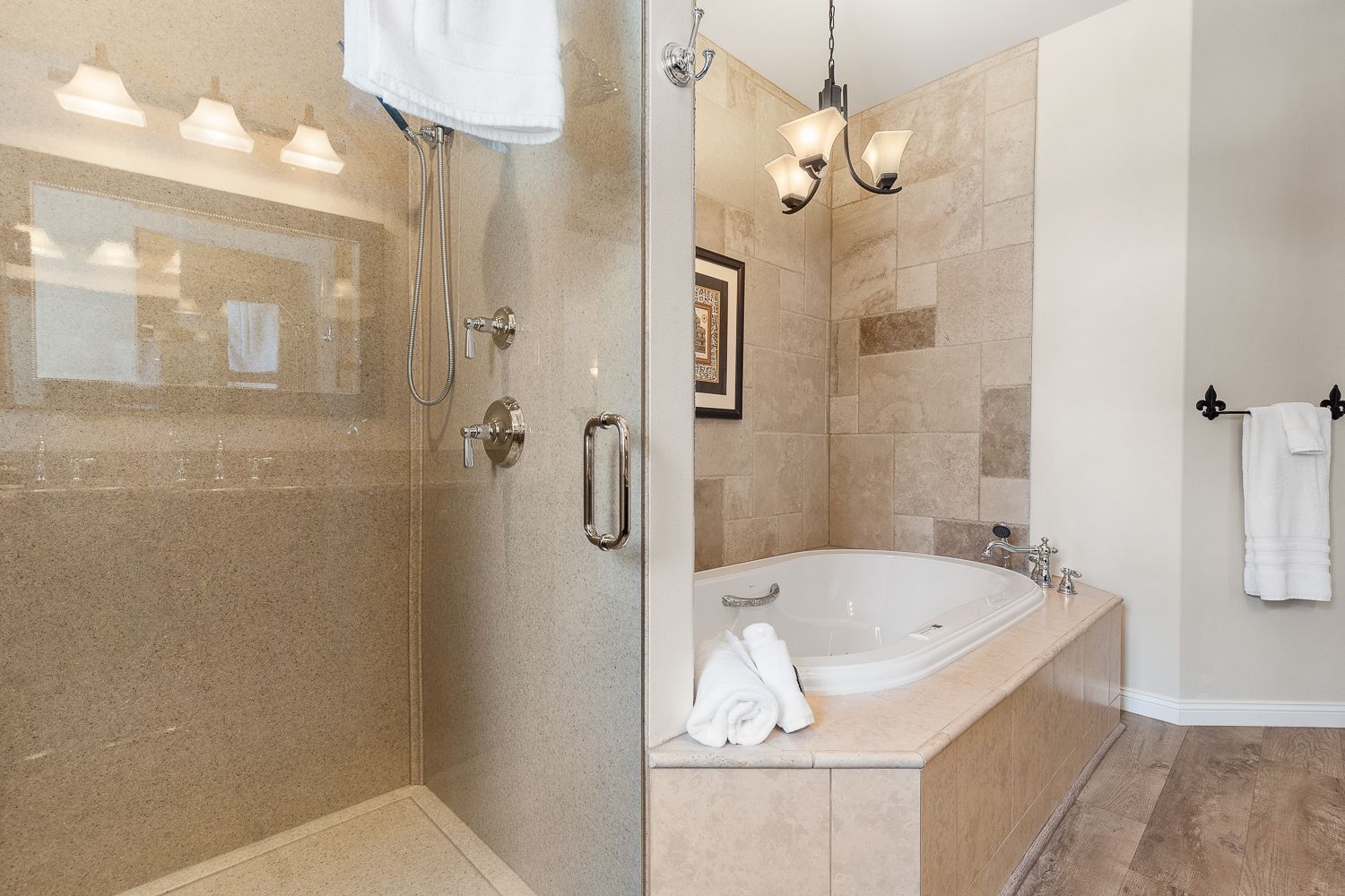 A bathroom with a walk in shower and a bathtub.