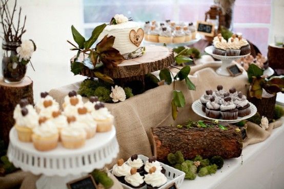 A table topped with cupcakes and a cake.