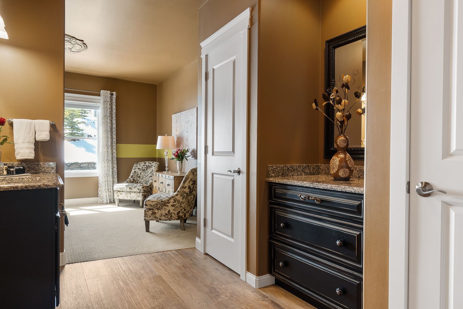 A bathroom with a sink , dresser and mirror.