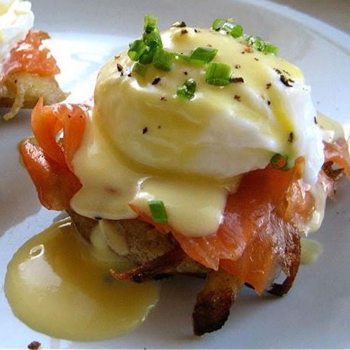 A close up of a plate of food with a poached egg on top