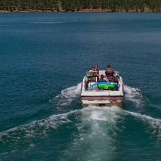 A boat is floating on top of a large body of water.