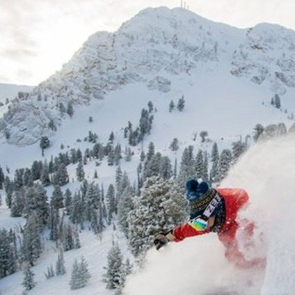 A person is skiing down a snow covered mountain.