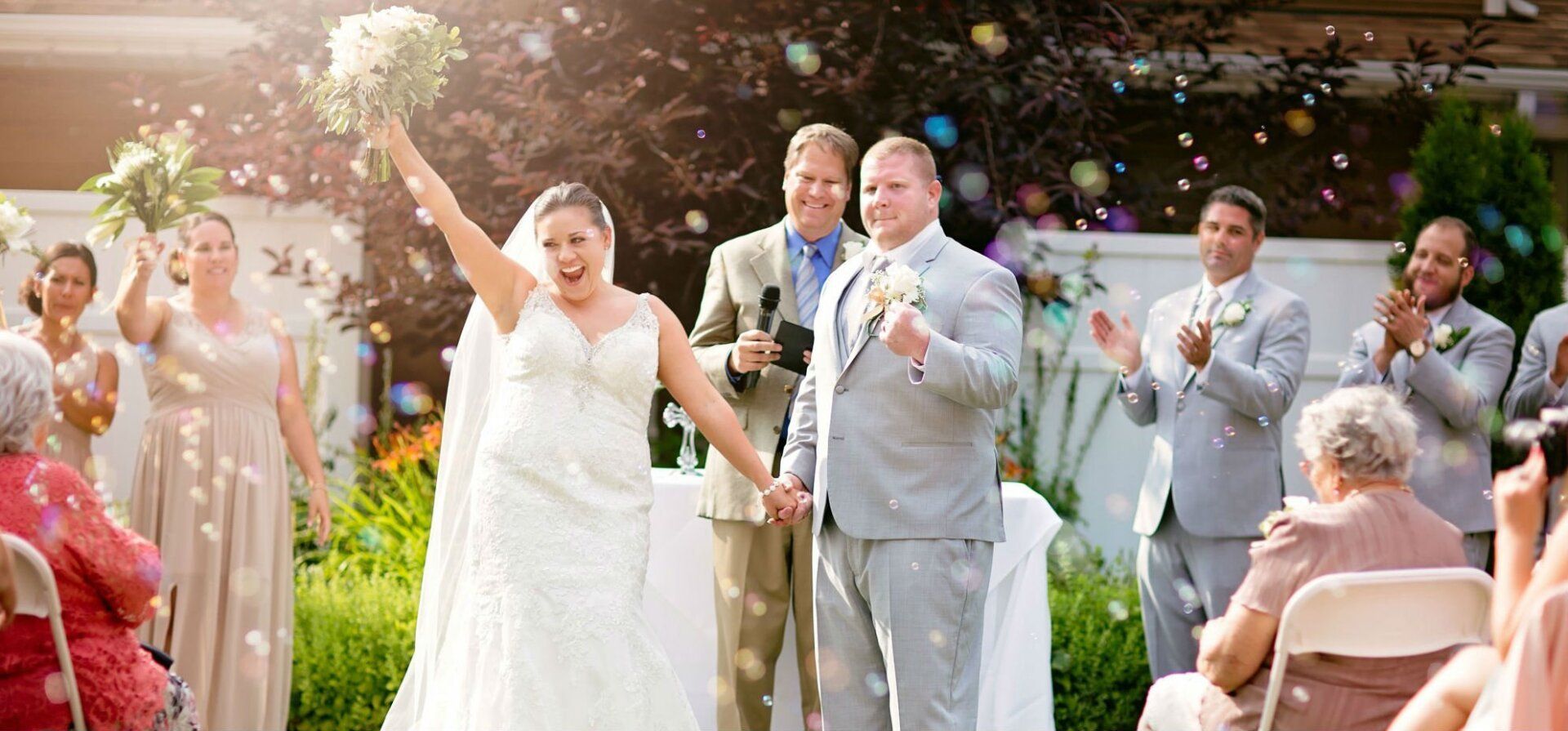 A bride and groom are celebrating their wedding with confetti being thrown in the air.