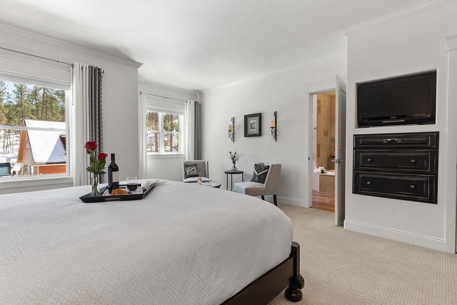 A bedroom with a king size bed and a flat screen tv.