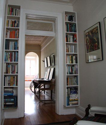 skinny bookshelves by entryway