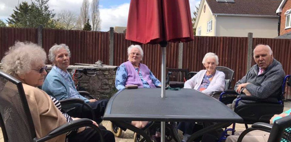 Residents sitting in garden at Avon Park Care Home Southampton