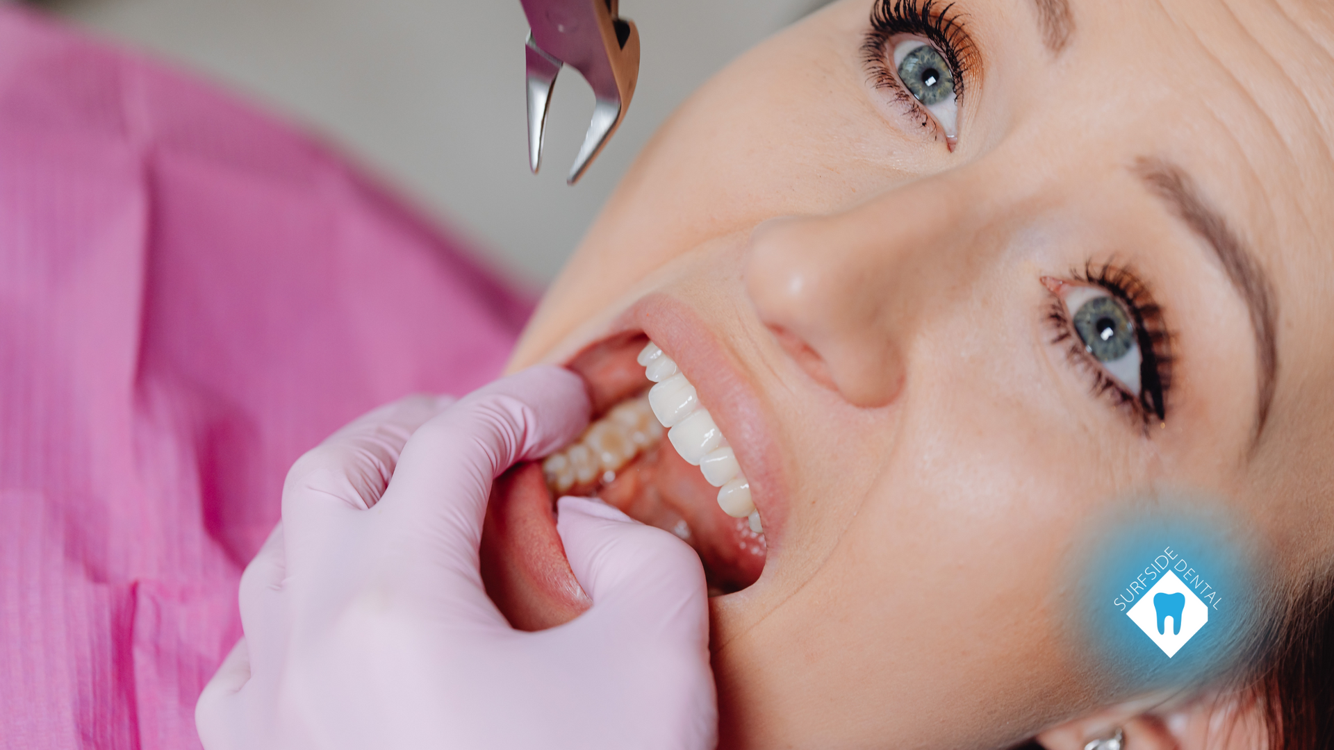 A woman is getting her teeth examined by a dentist.