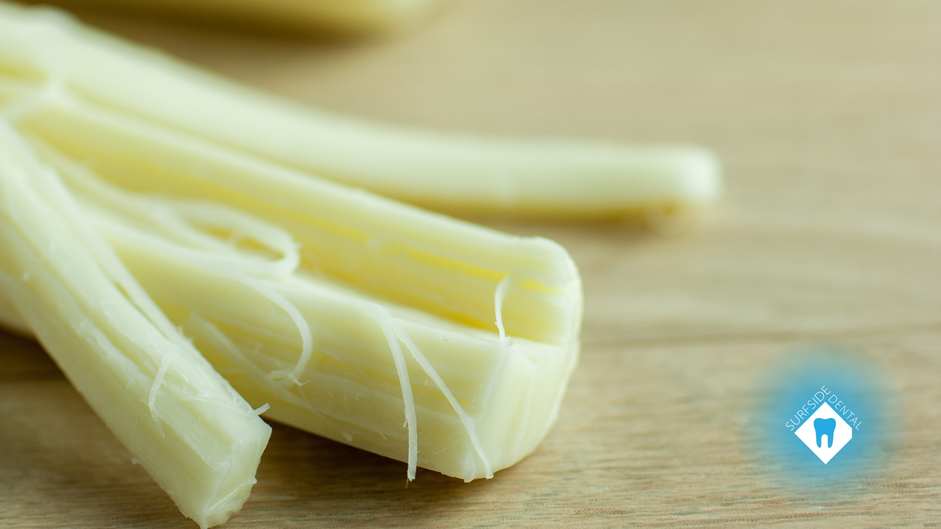 A close up of a piece of cheese on a wooden table.