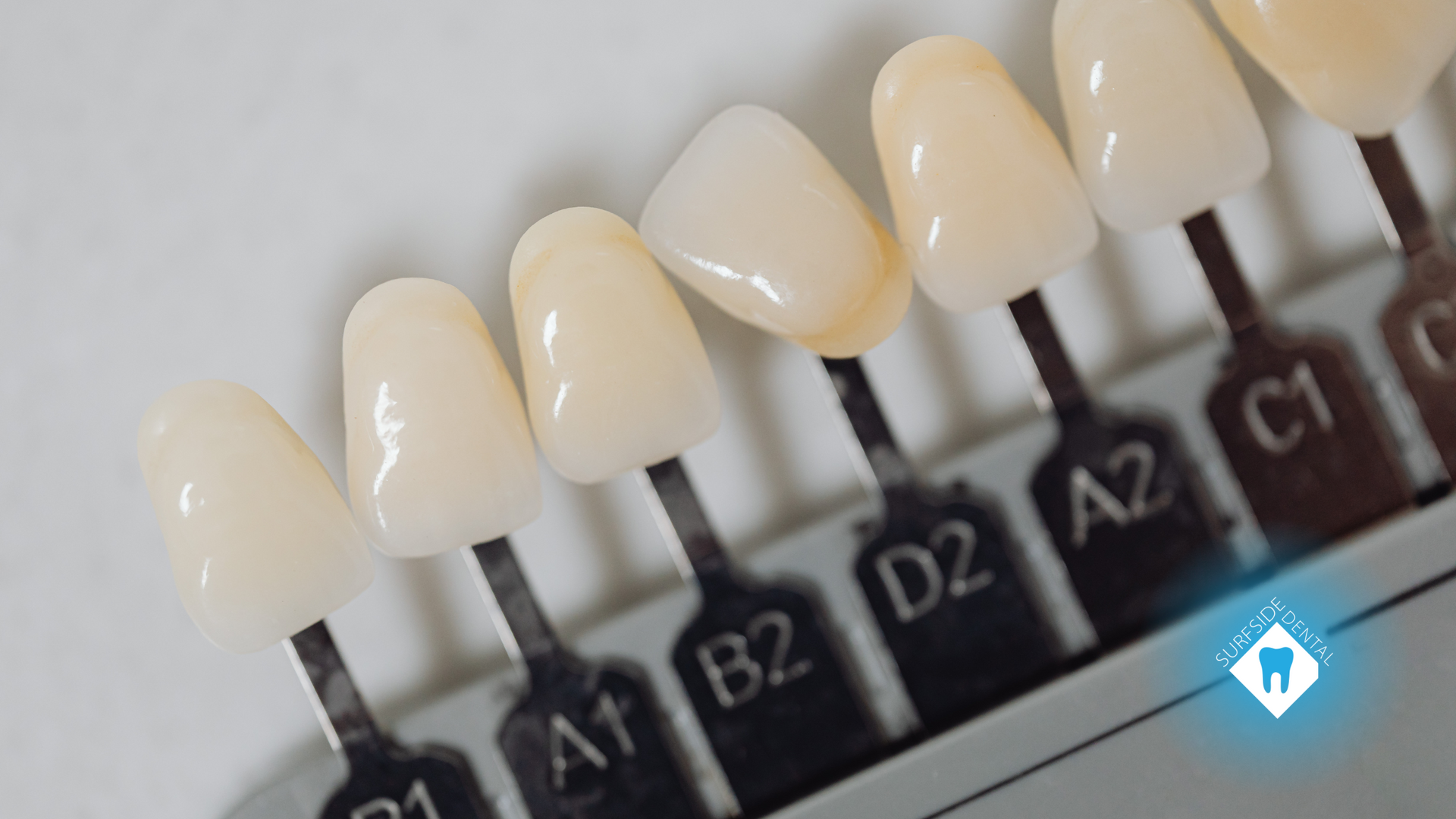 A close up of a tooth color chart with different shades of white teeth.
