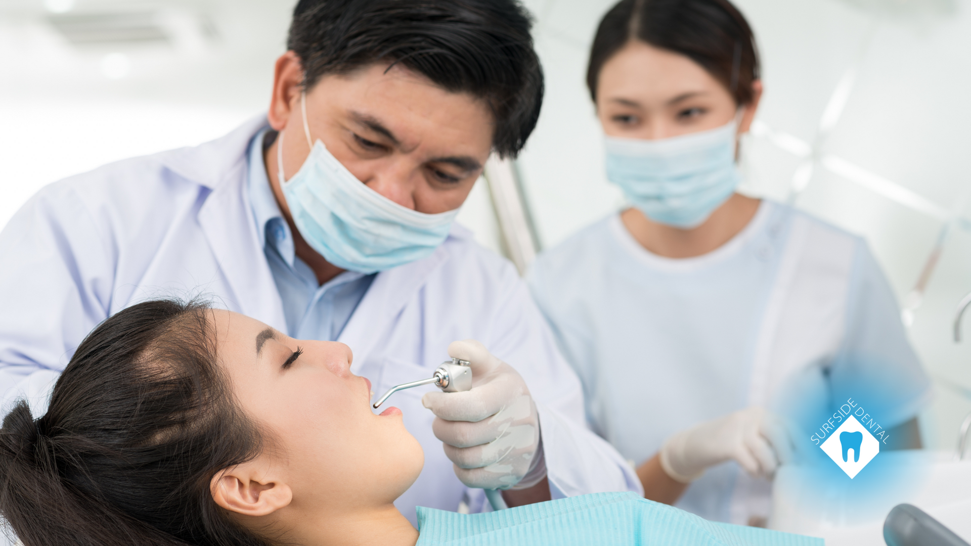 A dentist is examining a woman's teeth in a dental office.