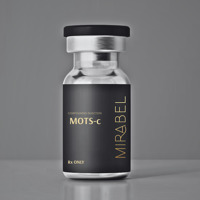 Bottle of Mirabel MOTS-C injection vial, black label with gold lettering on a gray background.