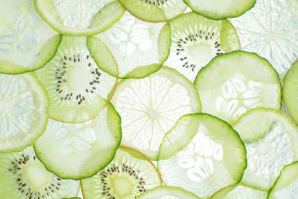 Thin, translucent slices of kiwi, cucumber, and lime in shades of green and white.