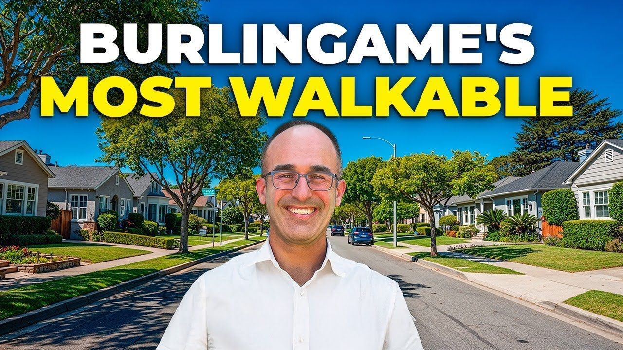 Man smiling in front of houses; text 