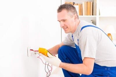 Electrician checking socket — 24/7 Electricians in Redlands, CA