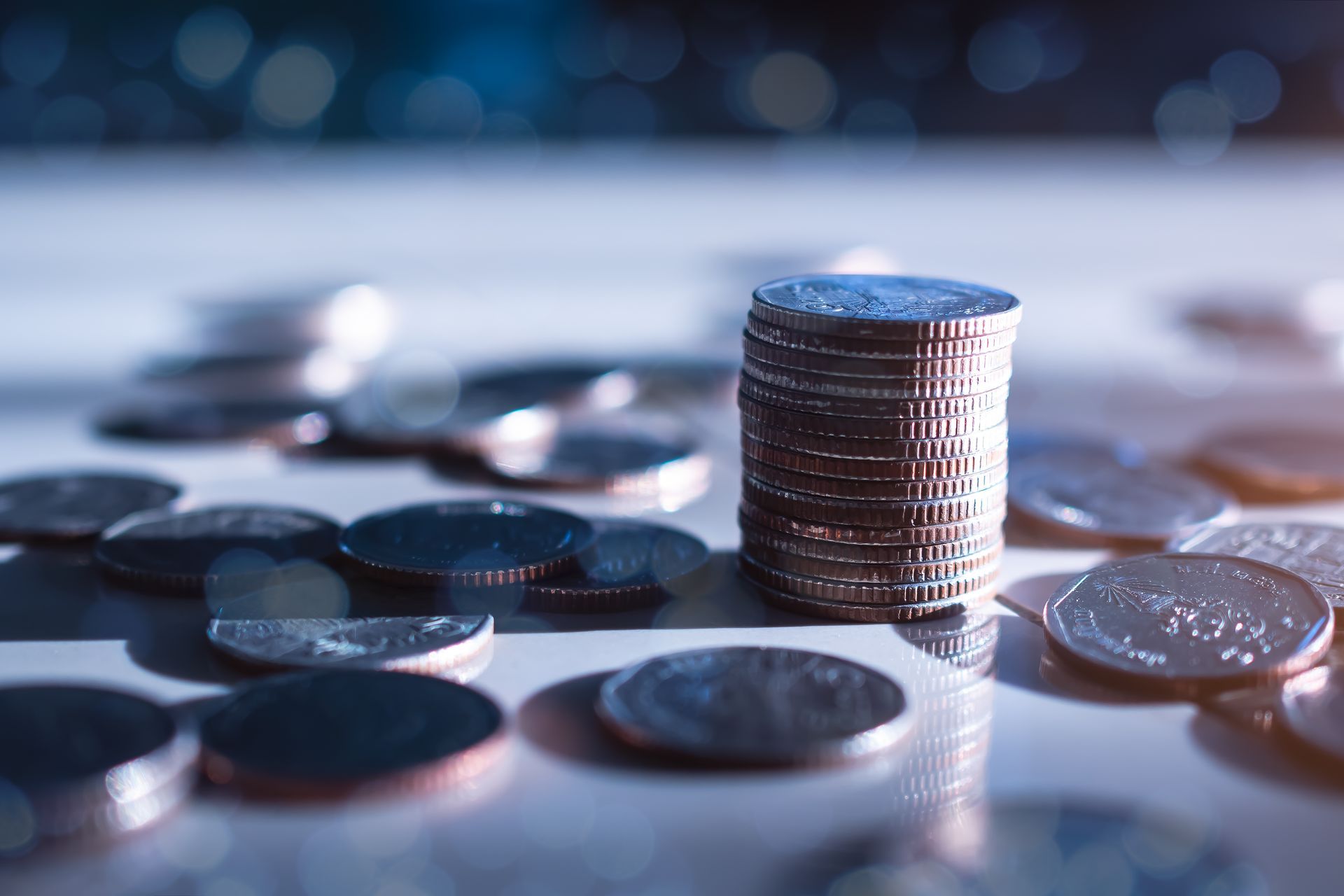 A stack of coins sitting on top of each other on a table.