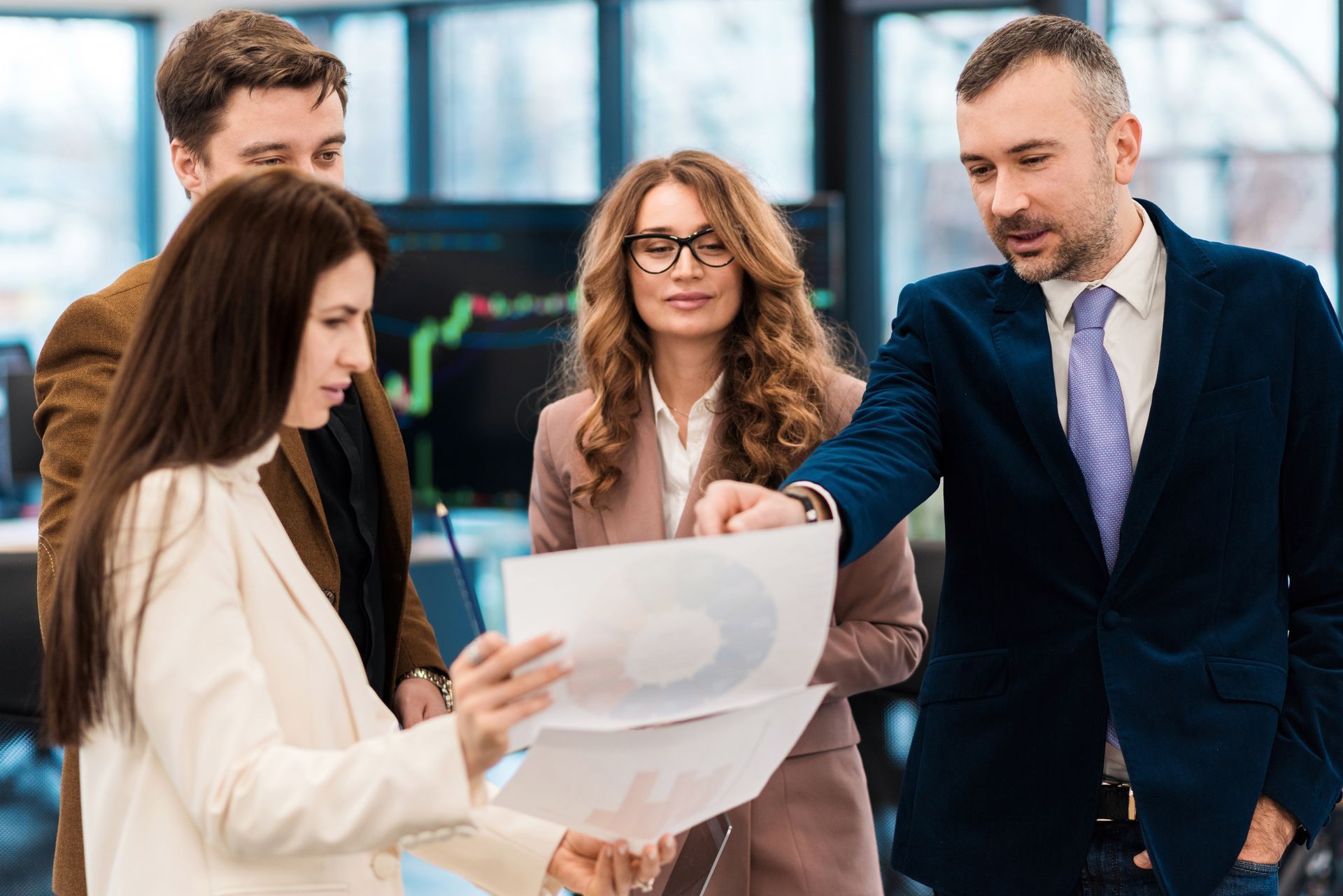 A group of business people are looking at a piece of paper.